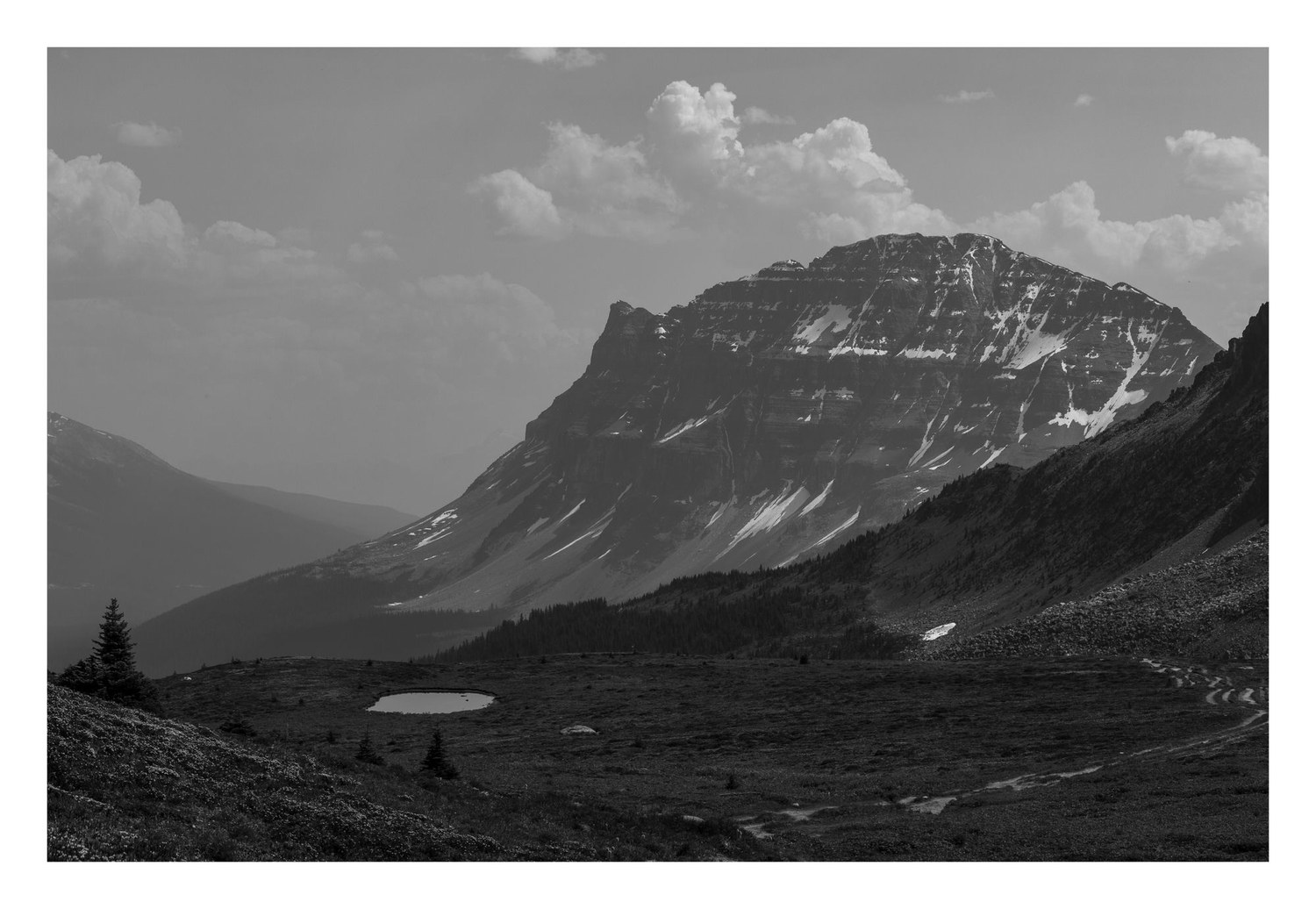 Black and white mountain valley with an alpine tarn