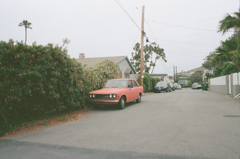 Vintage red car on beach street