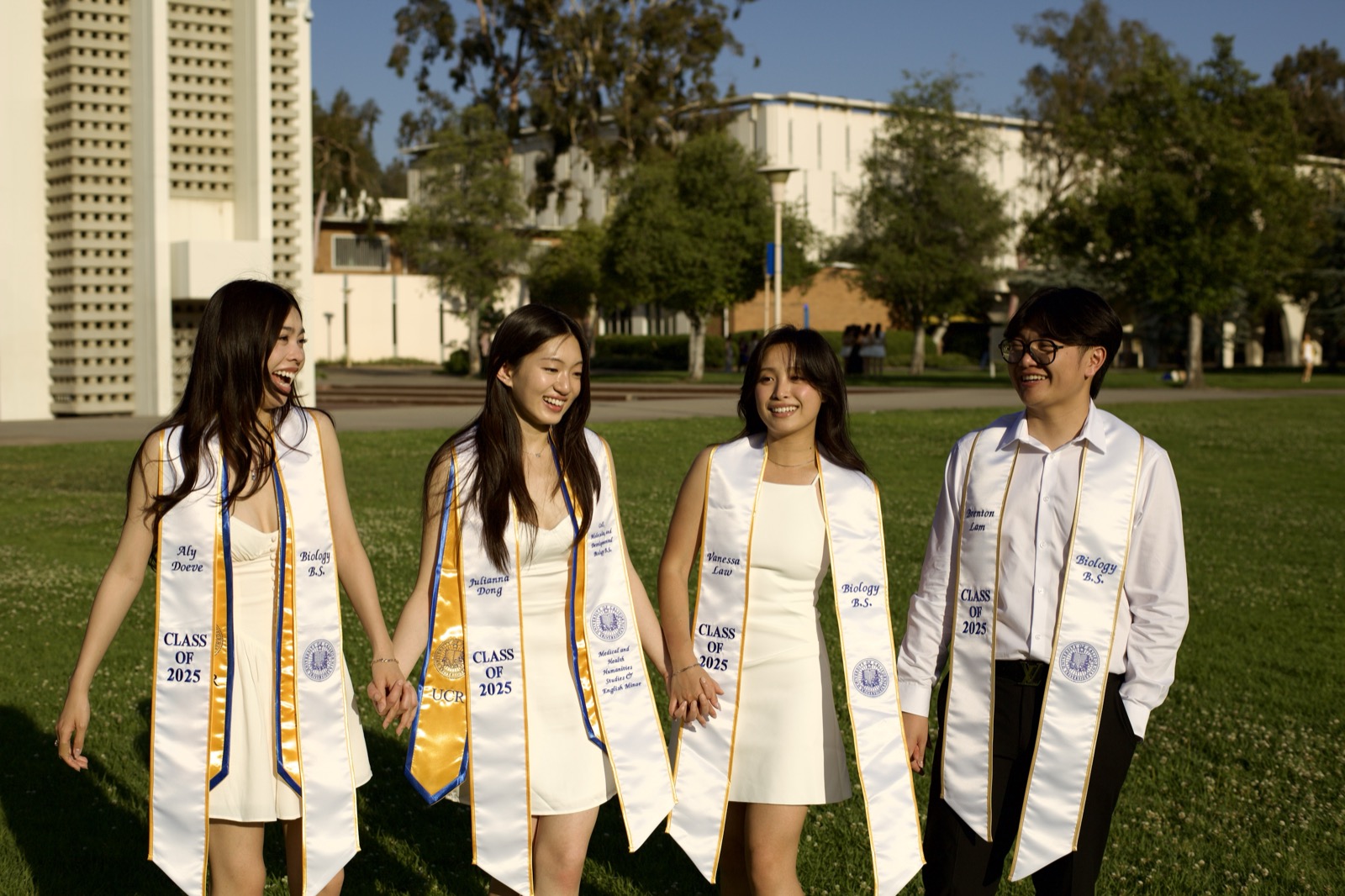 Group laughing on campus lawn