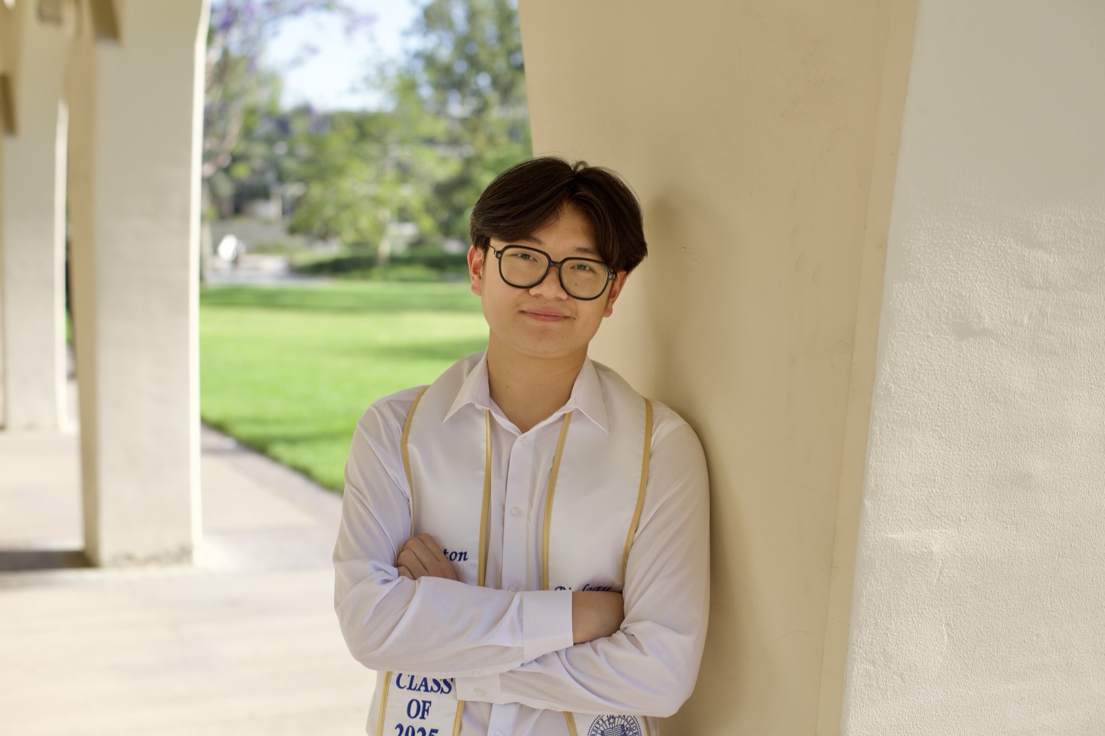 Graduate portrait arms crossed in archway