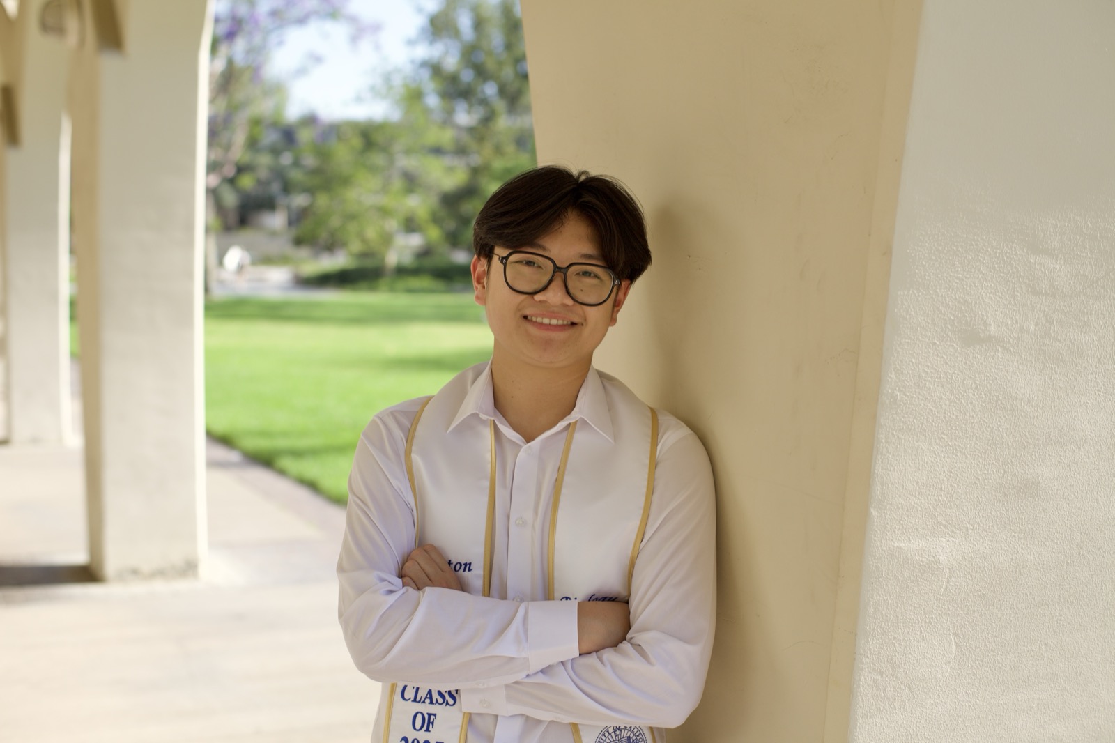 Graduate arms crossed in archway